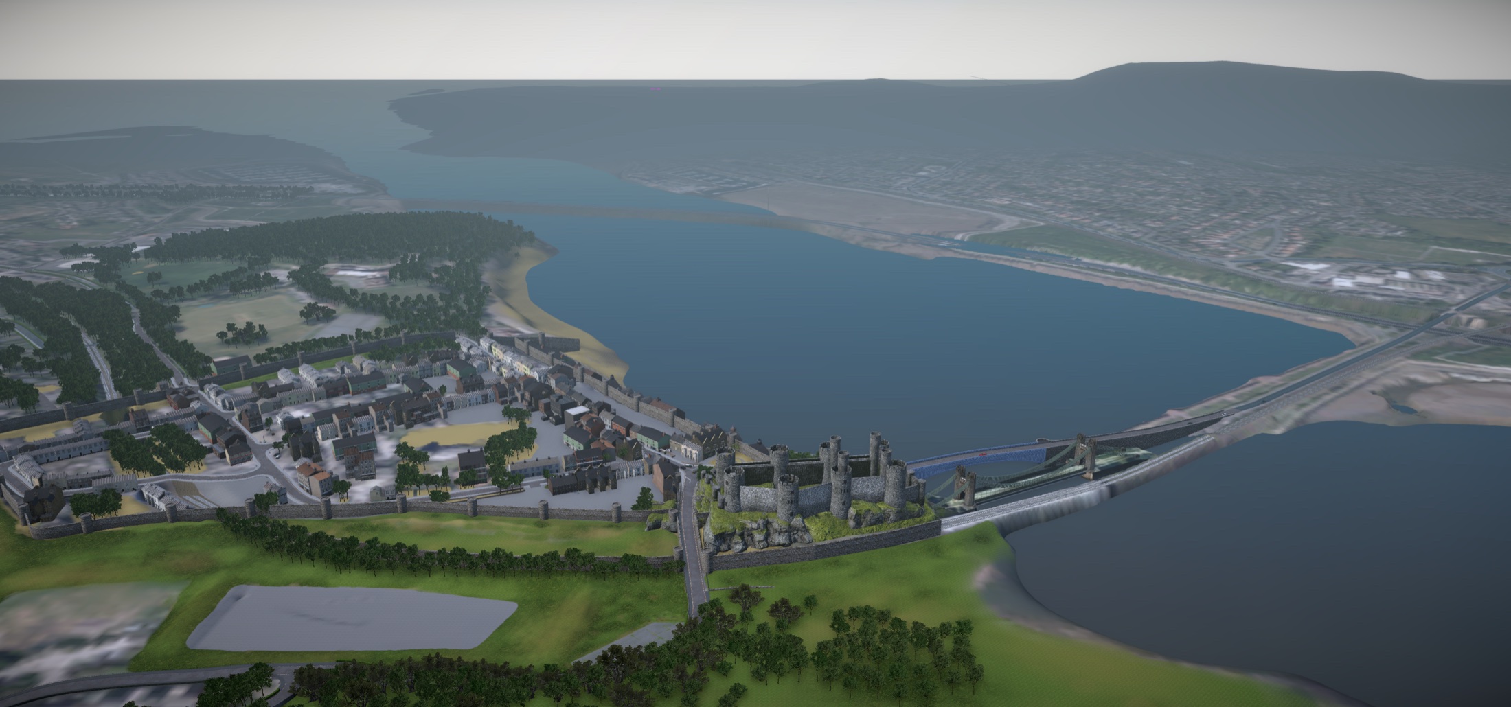Aerial view of a simulated Conwy, with its castle, streets, bridges and estuary.